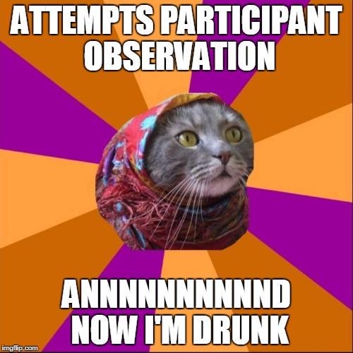 image of a cat’s head with a pink floral headscarf in center surrounded by pink and orange alternating triangle pattern increasing in size from center to emphasize the cat. Upper text reads “Attempts participant observation” and bottom text reads “Annnnnnnd now I’m drunk”
