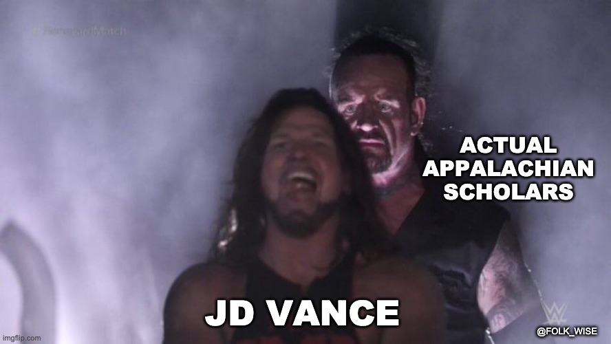 image of two light-skinned very muscular men; wrestler AJ Styles stand in front, looking completely unassuming, while the Undertaker, standing behind him with a foreboding look, about to take him down in a fight. Text over AJ reads “JD Vance” and text over the Undertaker reads “actual Appalachian scholars.”