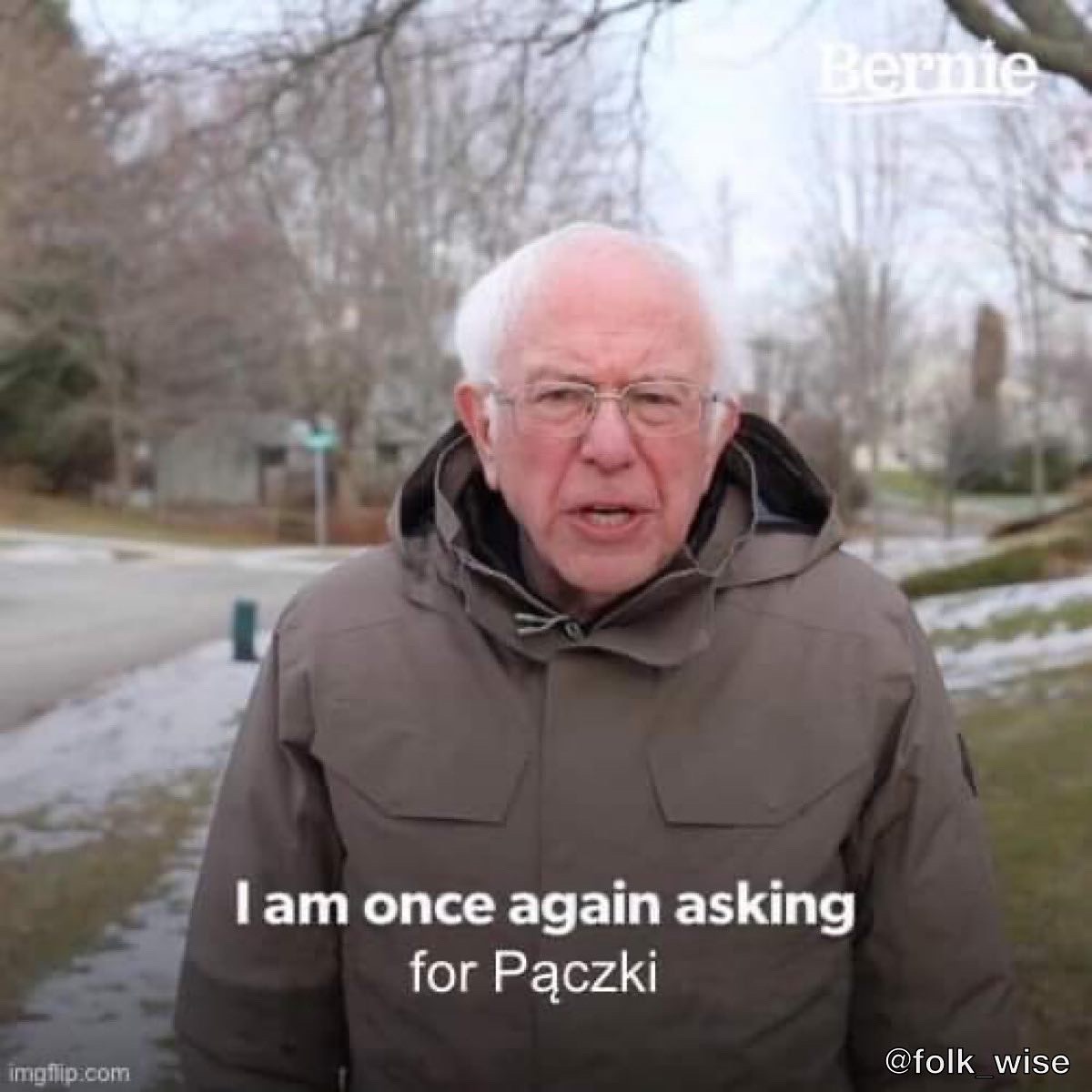 An older man, balding and with white hair wears a gray coat. He stands on a sidewalk in a neighborhood, with some snow visible on the ground. He is speaking, and the text reads "I am once again asking for Pączki"